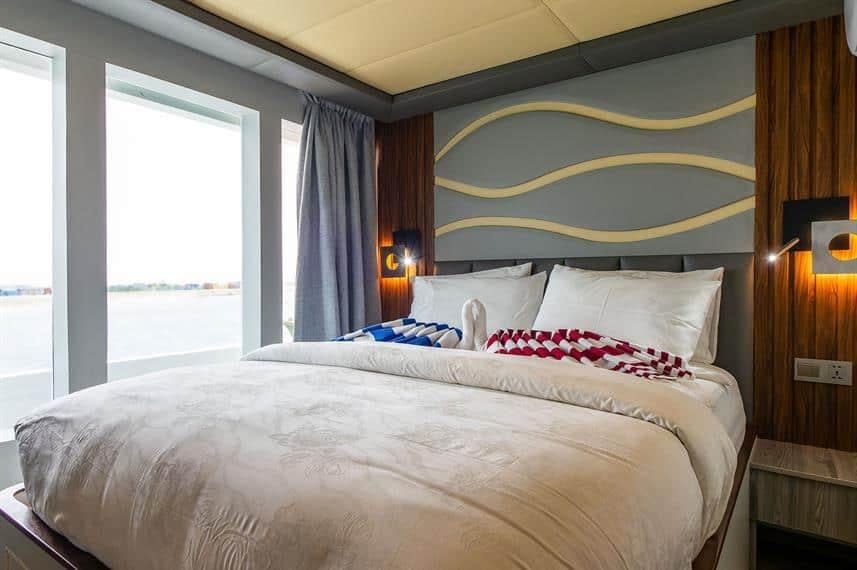 Double cabin: En-suite, with its own air conditioning, a wave-carved headboard and wide windows onto the water.